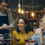 a group of friends ordering wine at a restaraunt