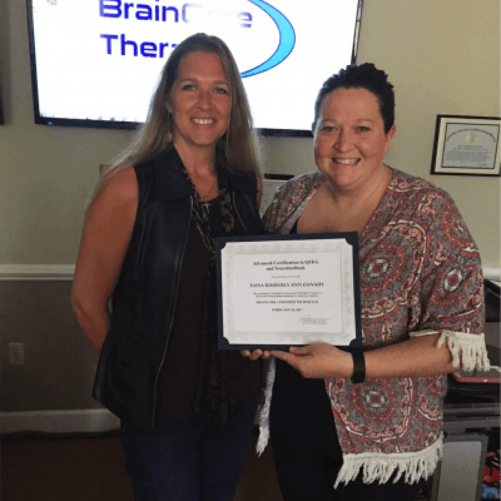 two women holding a certificate